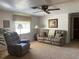 Comfortable living room with a plush recliner, sofa, ceiling fan, and natural light at 2216 Huntington Ave, Sarasota, FL 34232