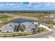 Aerial view of new construction homes with lush landscaping and a scenic pond at 260 Van Gogh Cv, Bradenton, FL 34212
