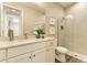 Elegant bathroom featuring a glass-enclosed shower and a vanity with white marble countertop at 260 Van Gogh Cv, Bradenton, FL 34212