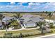 New construction single Gathering home featuring tropical landscaping, a brick walkway, and a white picket fence at 260 Van Gogh Cv, Bradenton, FL 34212