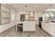 Bright kitchen featuring white cabinetry, a center island with seating, and modern appliances at 260 Van Gogh Cv, Bradenton, FL 34212
