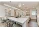 Modern kitchen with white countertops, island seating, and stylish pendant lighting at 260 Van Gogh Cv, Bradenton, FL 34212
