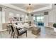 Stylish living room with contemporary furnishings, a decorative chandelier, and sliding glass doors at 260 Van Gogh Cv, Bradenton, FL 34212