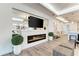 Living room with fireplace and open plan, neutral decor, and modern lighting at 260 Van Gogh Cv, Bradenton, FL 34212
