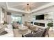 Bright living room features modern ceiling detail, stylish fireplace, and seamless indoor-outdoor living at 260 Van Gogh Cv, Bradenton, FL 34212