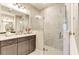 Modern bathroom featuring stone-look tile, glass shower, and double sink vanity with neutral tones at 264 Van Gogh Cv, Bradenton, FL 34212