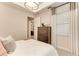 Bedroom featuring tray ceiling, large window, a four-drawer bureau, and carpeted floors at 264 Van Gogh Cv, Bradenton, FL 34212