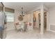 Cozy dining area featuring a built-in bench, glass table, and view of the hallway at 264 Van Gogh Cv, Bradenton, FL 34212