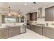 Contemporary kitchen with stainless steel appliances, ample counter space, and view of the living area at 264 Van Gogh Cv, Bradenton, FL 34212