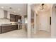 Modern kitchen with stainless steel appliances, dark wood cabinets, and an adjacent dining area at 264 Van Gogh Cv, Bradenton, FL 34212