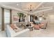 Elegant living room featuring tray ceiling, stylish furnishings, and an open layout leading to the kitchen at 264 Van Gogh Cv, Bradenton, FL 34212