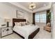 Comfortable main bedroom with a decorative accent wall and tray ceiling at 264 Van Gogh Cv, Bradenton, FL 34212