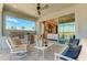 Inviting covered patio with outdoor kitchen, ceiling fan, and comfortable seating overlooking manicured landscaping at 264 Van Gogh Cv, Bradenton, FL 34212