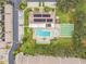 Community aerial view featuring a pool, shuffleboard courts, green spaces and complex buildings with solar panels at 2774 71St St Ct W # 2101, Bradenton, FL 34209