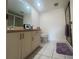 Bright bathroom featuring a framed mirror, spacious vanity, and a glass-enclosed shower at 2774 71St St Ct W # 2101, Bradenton, FL 34209