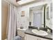 Bathroom with gray countertops, decorative wallpaper, and a combined shower and tub at 2774 71St St Ct W # 2101, Bradenton, FL 34209