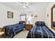 Cozy bedroom featuring two twin beds with blue striped bedding and neutral colored walls at 2774 71St St Ct W # 2101, Bradenton, FL 34209