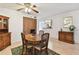 Dining room with seating for four, hardwood floors, ceiling fan, and adjacent kitchen at 2774 71St St Ct W # 2101, Bradenton, FL 34209
