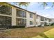 Exterior view of a condo building showcasing a well-maintained lawn and lush greenery at 2774 71St St Ct W # 2101, Bradenton, FL 34209