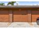 Attached multi-car garage featuring secure doors, concrete driveway and tropical landscaping at 2774 71St St Ct W # 2101, Bradenton, FL 34209