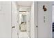 Hallway view of the guest bathroom, featuring white tile flooring and neutral colored walls at 2774 71St St Ct W # 2101, Bradenton, FL 34209