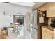 Bright kitchen with tile floors, stainless steel refrigerator and a view of a table near the back patio at 2774 71St St Ct W # 2101, Bradenton, FL 34209
