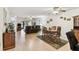 Open living room with hardwood floors, ceiling fans, and dining area with seating for six at 2774 71St St Ct W # 2101, Bradenton, FL 34209