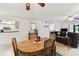 Open living room with hardwood floors, ceiling fans, and adjacent dining and kitchen areas at 2774 71St St Ct W # 2101, Bradenton, FL 34209