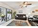 Cozy living room with comfortable seating, hardwood floors, ceiling fan, and adjacent sunroom at 2774 71St St Ct W # 2101, Bradenton, FL 34209