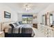 Bright main bedroom featuring a large window, ceiling fan, and light-colored wooden floors at 2774 71St St Ct W # 2101, Bradenton, FL 34209