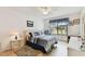 Bright main bedroom with large window, ceiling fan, and neutral decor at 2774 71St St Ct W # 2101, Bradenton, FL 34209