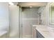 Modern bathroom featuring a glass shower and gray vanity with modern fixtures at 279 Park Forest Blvd, Englewood, FL 34223