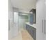Bathroom showcasing double vanities, gray cabinets, and a glass shower at 279 Park Forest Blvd, Englewood, FL 34223