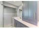 Contemporary bathroom with glass shower, gray vanity, and modern fixtures at 279 Park Forest Blvd, Englewood, FL 34223