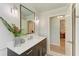 Modern bathroom vanity, large mirror, and a decorative house plant near a doorway at 279 Park Forest Blvd, Englewood, FL 34223