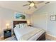 Bright bedroom with a comfortable bed and beach themed artwork, and a convenient closet at 279 Park Forest Blvd, Englewood, FL 34223