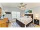 Relaxing bedroom with tropical decor, ceiling fan and cozy furnishings at 279 Park Forest Blvd, Englewood, FL 34223