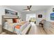 Bright bedroom with wood accents, ceiling fan, and access to sitting area at 279 Park Forest Blvd, Englewood, FL 34223