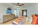 Cozy bedroom featuring wood-look floors, ceiling fan, and modern dresser at 279 Park Forest Blvd, Englewood, FL 34223