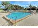 Large community pool with a brick pool deck, ladder access and a clear blue sky at 279 Park Forest Blvd, Englewood, FL 34223