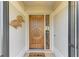 Inviting front entryway features a custom wood door with sidelight and coastal decor at 279 Park Forest Blvd, Englewood, FL 34223