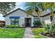Close up of the front entrance featuring neat landscaping around the walkway, and a storm door at 279 Park Forest Blvd, Englewood, FL 34223