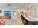 Open kitchen featuring a large island with marble countertop and pendant lighting, ideal for entertaining at 279 Park Forest Blvd, Englewood, FL 34223