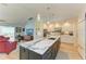 Bright kitchen with a spacious island, white cabinets, and modern stainless steel appliances at 279 Park Forest Blvd, Englewood, FL 34223