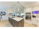 Stylish kitchen showcasing a large island, stainless steel appliances, and an open layout to the living area at 279 Park Forest Blvd, Englewood, FL 34223