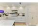 Elegant kitchen featuring marble backsplash, white cabinetry, stainless steel appliances, and ample counter space at 279 Park Forest Blvd, Englewood, FL 34223