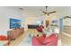 Bright living room featuring wood floors and an open layout to the modern kitchen at 279 Park Forest Blvd, Englewood, FL 34223