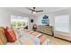 Bright main bedroom with a comfortable seating area, and an entertainment center at 279 Park Forest Blvd, Englewood, FL 34223