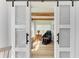 Bright office space featuring frosted glass barn doors and wood-beamed ceilings at 279 Park Forest Blvd, Englewood, FL 34223