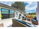 Relaxing outdoor patio features wicker furniture, a built-in kitchen, and inviting ambiance at 279 Park Forest Blvd, Englewood, FL 34223
